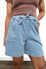 Light blue denim shorts worn by a person on a neutral background
