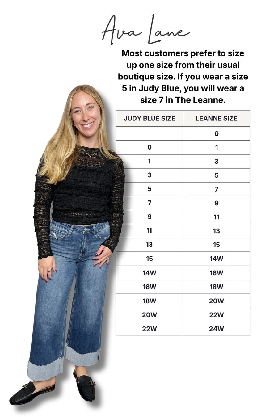 Person wearing a black top and blue jeans with a size chart on a white background