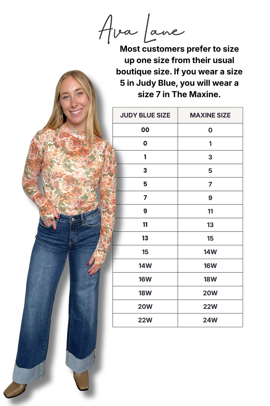 Woman wearing a floral top and jeans with a size chart on a white background