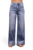 A model wearing light blue wide-leg jeans with a faded wash and rolled cuffs, paired with a light pink off-the-shoulder crop top, shown against a plain white background.