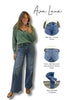 Woman wearing blue jeans with product details on a white background