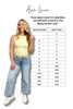 Woman holding a size chart for Ava Lane clothing, showing size equivalencies between Judy Blue and Becky lines.