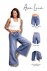 Woman wearing blue jeans with product features highlighted on a white background