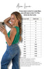 Woman in green top and blue jeans with size chart on a white background