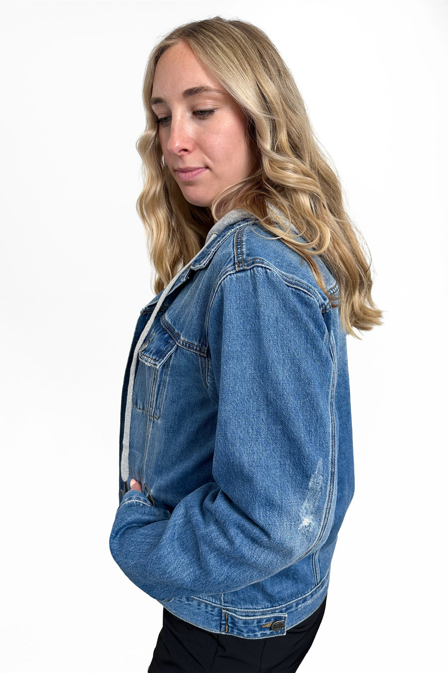 Woman wearing a blue denim jacket on a white background