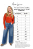 Woman wearing an orange top and blue jeans with a size chart on a white background, featuring the brand 'Ava Lane'.