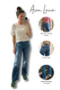 Woman taking a mirror selfie wearing blue jeans and a white lace top, with 'Ava Lane' branding and product features.