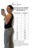 Person taking a selfie with a size chart for Ava Lane clothing, showing size conversion between Judy Blue and The Storm.