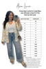 Woman taking a selfie wearing a floral cardigan and jeans, with a size chart for Ava Lane clothing on a white background.