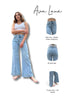 Woman wearing light blue jeans with Ava Lane branding and product details.