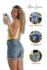 Woman taking a selfie wearing denim shorts with product features highlighted.